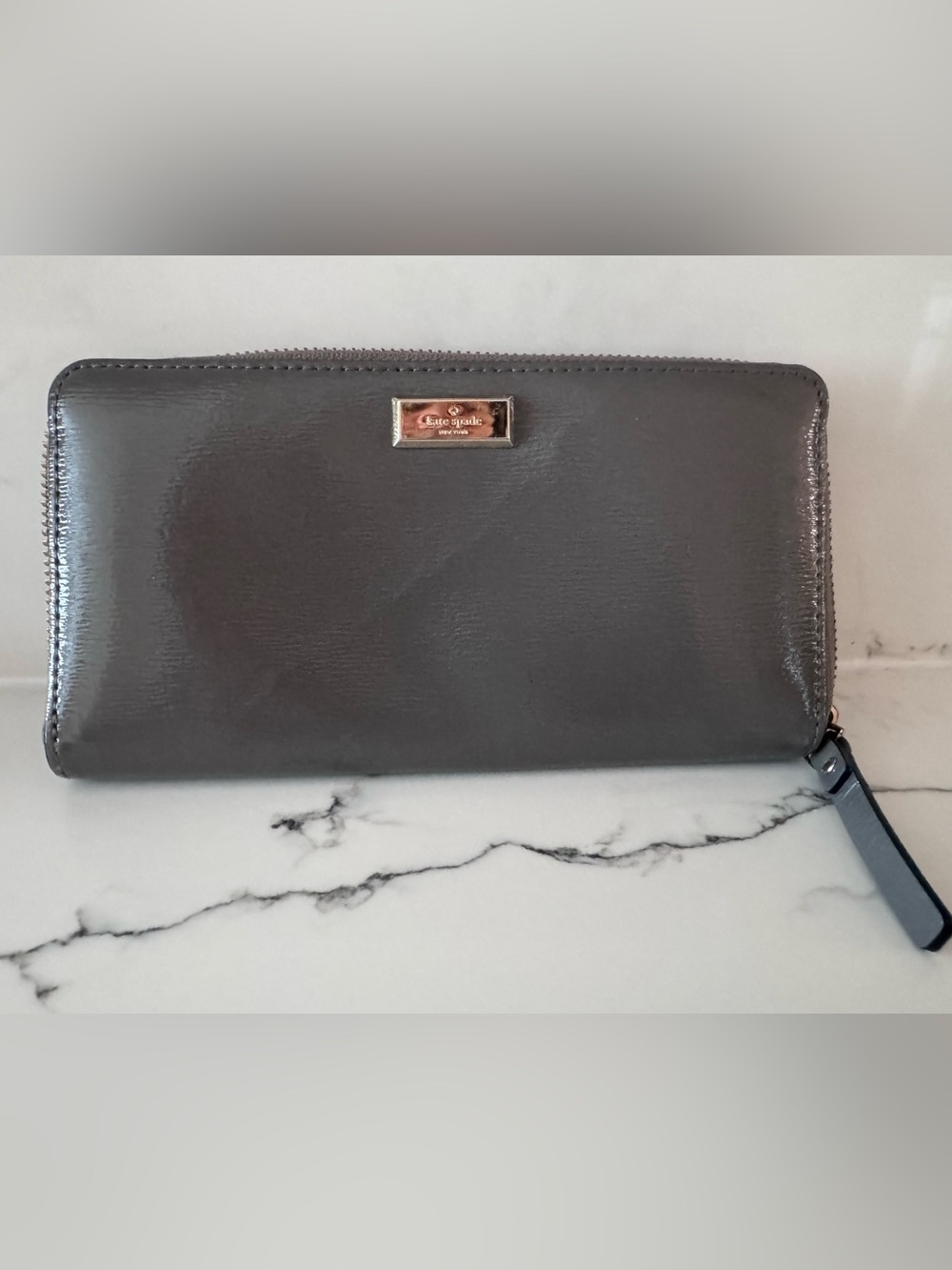 kate spade charcoal gray zip clutch with gold plaque